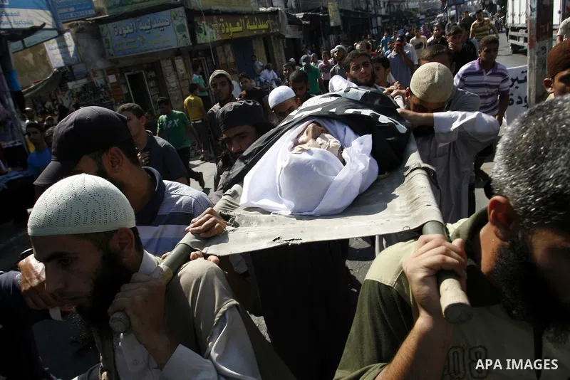 Mourners carry the body of a Palestinian militant Eid Hejazi during his funeral in Rafah, southern Gaza Strip, Sunday, Aug. 5, 2012. Hejazi was killed on an Israeli air strike on Sunday and was a member of the Popular Re...
