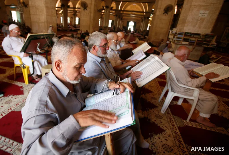 Palestinians read the holy Qur'an at al-Aqsa Mosque in Jerusalem's Old City during the holy month of Ramadan, on 26 July 2012. Muslims around the world abstain from eating, drinking and conducting sexual relations from d...