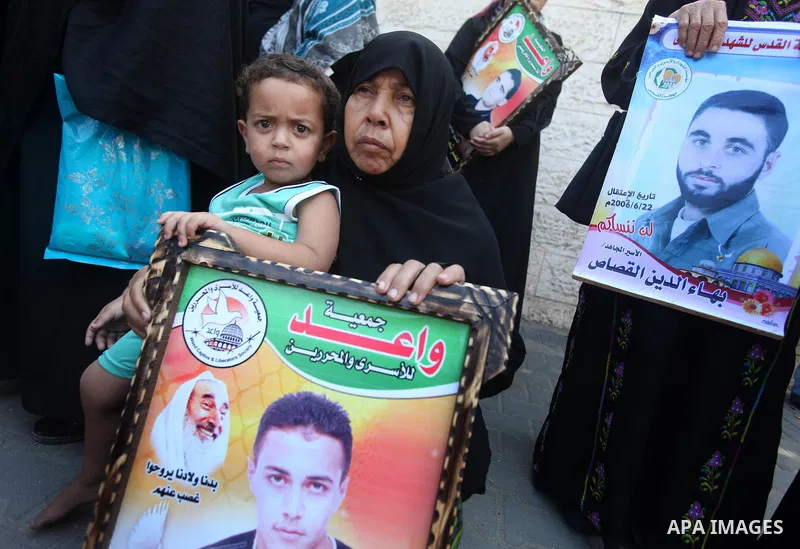 Palestinian relatives prisoners attend a protest calling for the release of their sons held in Israeli jails in front of the headquarters Red Cross in Gaza City, Gaza Strip, on Aug.06, 2012. Photo by Majdi Fathi