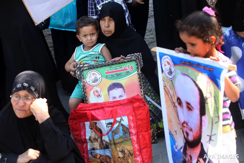 Palestinian relatives prisoners attend a protest calling for the release of their sons held in Israeli jails in front of the headquarters Red Cross in Gaza City, Gaza Strip, on Aug.06, 2012. Photo by Majdi Fathi