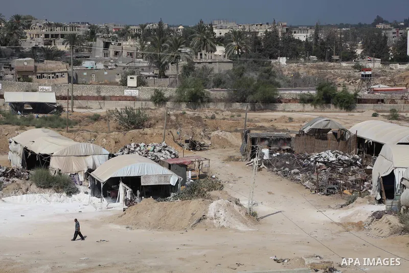 Tents cover entrances of tunnels (bottom) used for smuggling along the Gaza-Egypt border, near the southern Gaza Strip town of Rafah on August 06, 2012. Five gunmen who slew 16 Egyptian guards near the border with Israel...