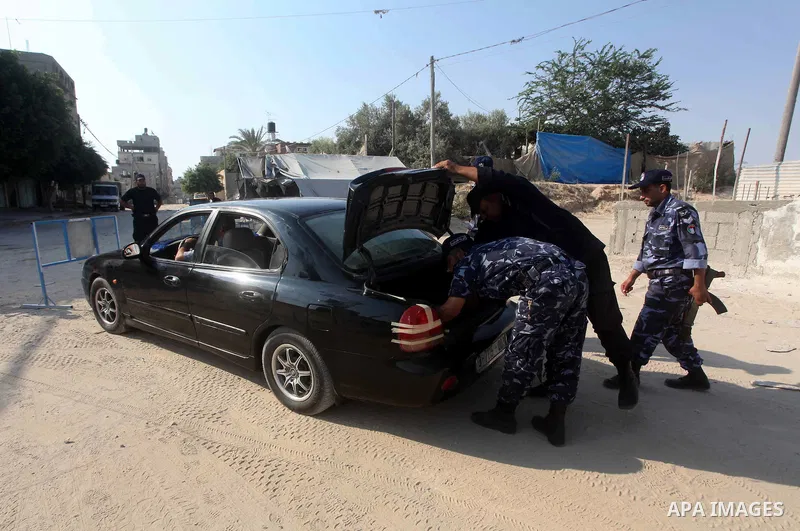 Palestinians Hamas security guard during searching cars near the border between Egypt and Gaza strip in Rafah town southern Gaza strip on, 06 August 2012. Reports state that at least five gunmen were killed after they tr...