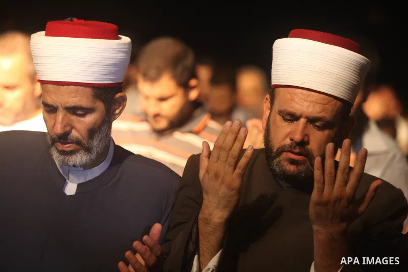 Palestinian Prime Minister in Gaza Ismail Haniyeh (not seen) leads a night prayer known as "Tarawih" at a sit-in tent in Gaza city, solidarity with Egyptian soldiers who were killed on Rafah border between Egypt and the...