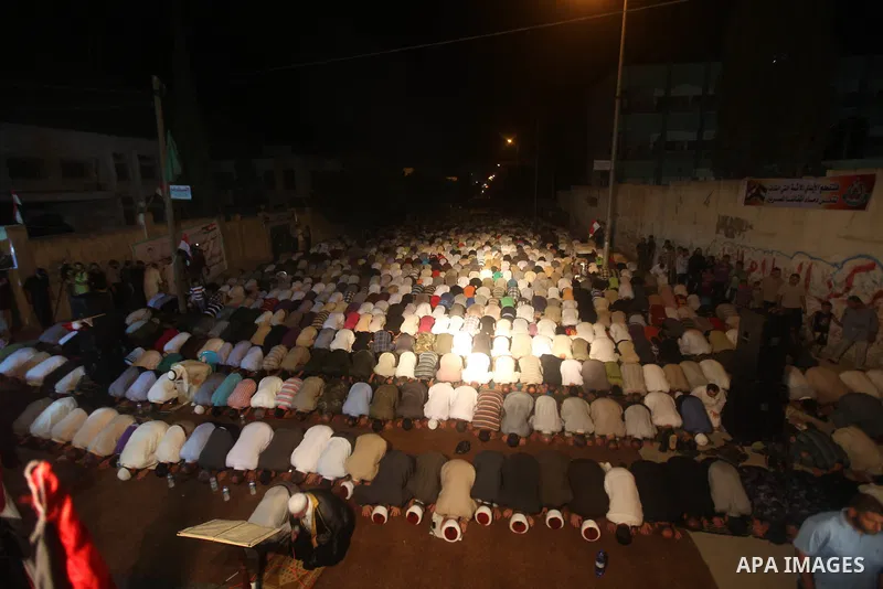 Palestinian Prime Minister in Gaza Ismail Haniyeh leads a night prayer known as "Tarawih" at a sit-in tent in Gaza city, solidarity with Egyptian soldiers who were killed on Rafah border between Egypt and the southern Ga...