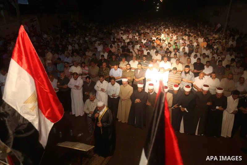 Palestinian Prime Minister in Gaza Ismail Haniyeh leads a night prayer known as "Tarawih" at a sit-in tent in Gaza city, solidarity with Egyptian soldiers who were killed on Rafah border between Egypt and the southern Ga...