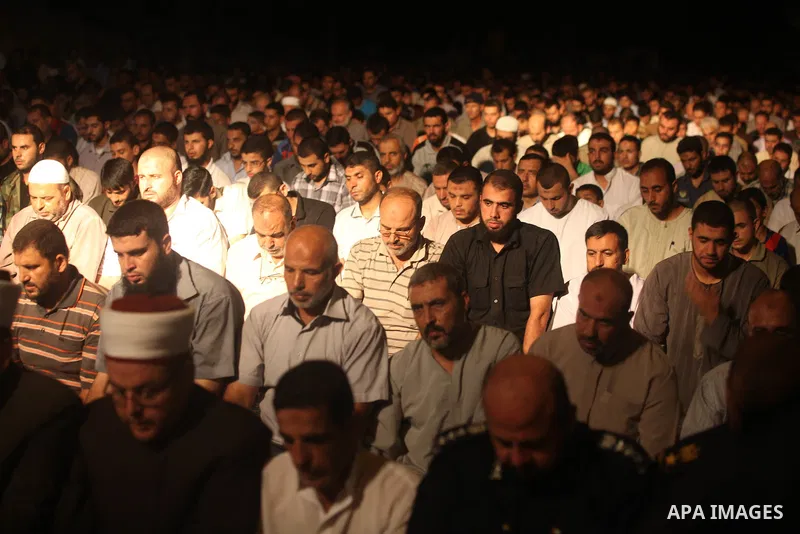 Palestinian Prime Minister in Gaza Ismail Haniyeh (not seen) leads a night prayer known as "Tarawih" at a sit-in tent in Gaza city, solidarity with Egyptian soldiers who were killed on Rafah border between Egypt and the...