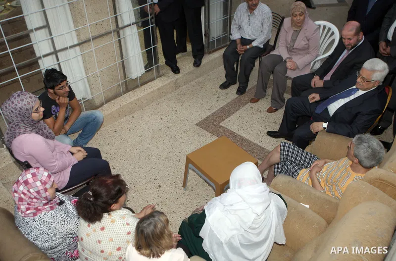 Palestinian President Mahmoud Abbas (Abu Mazen) visits a Palestinian indigent family during the holy month of Ramadan, in the West Bank city of Ramallah on 06 August 2012. Photo by Thaer Ganaim