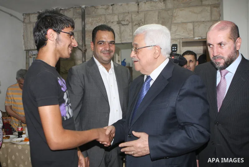 Palestinian President Mahmoud Abbas (Abu Mazen) visits a Palestinian indigent family during the holy month of Ramadan, in the West Bank city of Ramallah on 06 August 2012. Photo by Thaer Ganaim