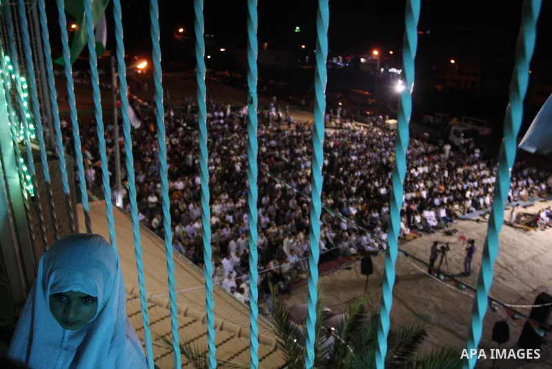 Palestinian girl looks on the a mosque during a night prayer known as "Tarawih" at the mosque in the West Bank city of Ramallah on Aug. 07, 2012. Photo by Issam Rimawi