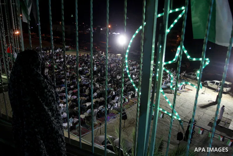 Palestinian girl looks on the a mosque during a night prayer known as "Tarawih" at the mosque in the West Bank city of Ramallah on Aug. 07, 2012. Photo by Issam Rimawi