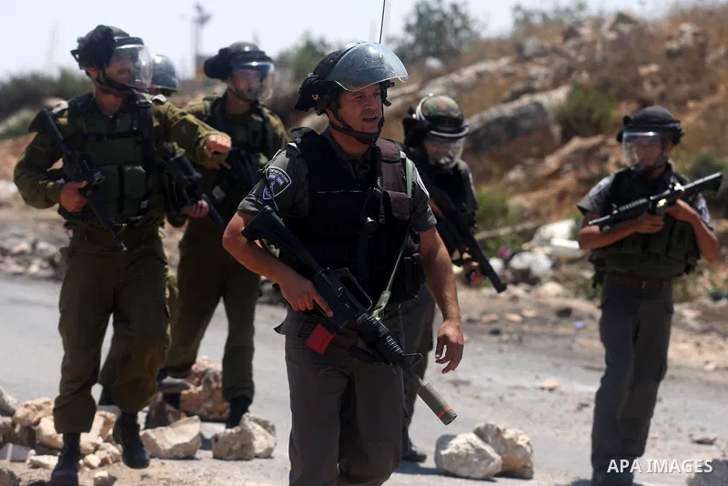 Israeli soldiers fire tear gas at Palestinian protestor during a Democratic Front for the Liberation of Palestine (DFLP) demonstration supporting prisoners in Israeli jails outside the Ofer military prison, near the West...