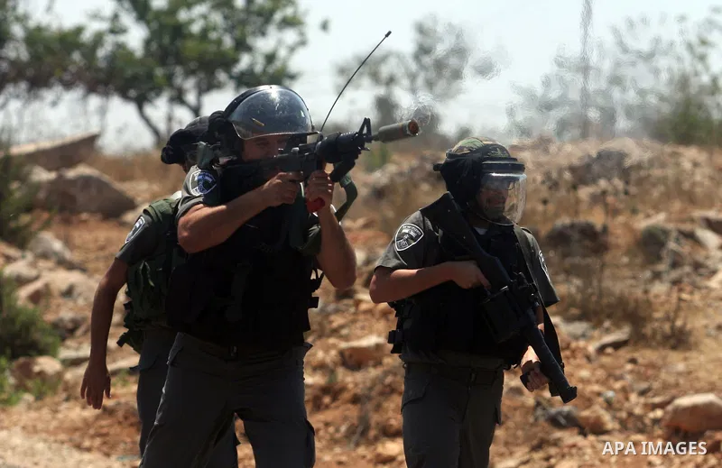 Israeli soldiers fire tear gas at Palestinian protestor during a Democratic Front for the Liberation of Palestine (DFLP) demonstration supporting prisoners in Israeli jails outside the Ofer military prison, near the West...