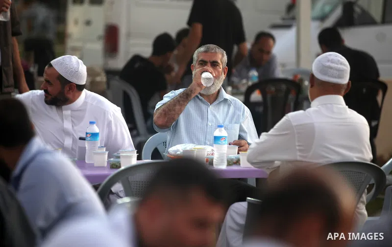 Palestinian Prime Minister in Gaza Strip, Ismail Haniyeh, breaks his fast with a Palestinian released Prisoners during the holy month of Ramadan, in Gaza city on 09 August 2012. Photo by Majdi Fathi