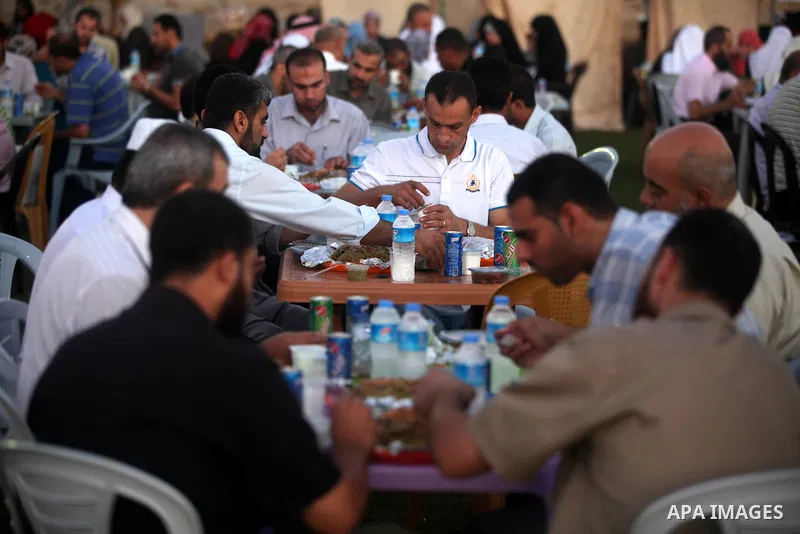 Palestinian Prime Minister in Gaza Strip, Ismail Haniyeh, breaks his fast with a Palestinian released Prisoners during the holy month of Ramadan, in Gaza city on 09 August 2012. Photo by Majdi Fathi