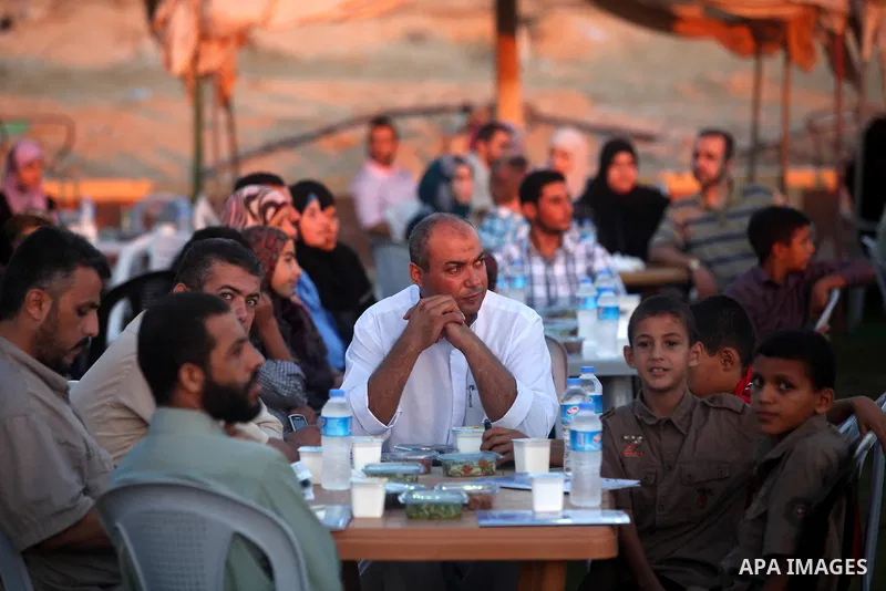 Palestinian Prime Minister in Gaza Strip, Ismail Haniyeh, breaks his fast with a Palestinian released Prisoners during the holy month of Ramadan, in Gaza city on 09 August 2012. Photo by Majdi Fathi