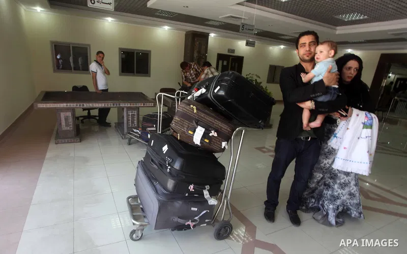 Palestinians return from Egypt cross into the southern Gaza Strip at the Rafah border crossing August 10, 2012. Egyptian military forces have captured six "terrorists" in the Sinai region after an attack on a police stat...