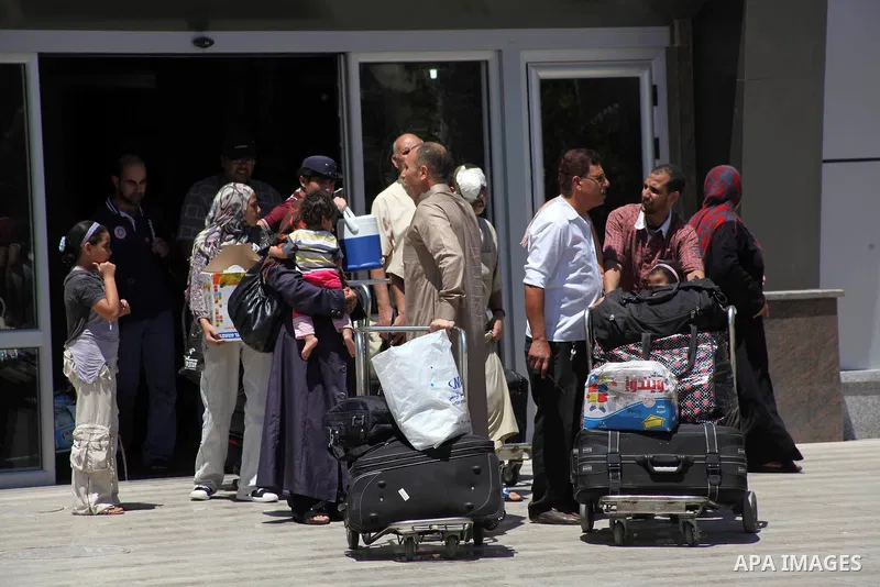 Palestinians return from Egypt cross into the southern Gaza Strip at the Rafah border crossing August 10, 2012. Egyptian military forces have captured six "terrorists" in the Sinai region after an attack on a police stat...