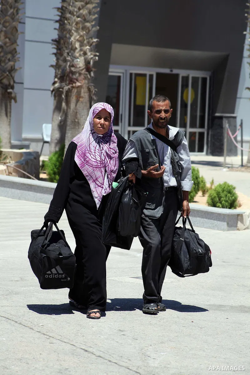 Palestinians return from Egypt cross into the southern Gaza Strip at the Rafah border crossing August 10, 2012. Egyptian military forces have captured six "terrorists" in the Sinai region after an attack on a police stat...