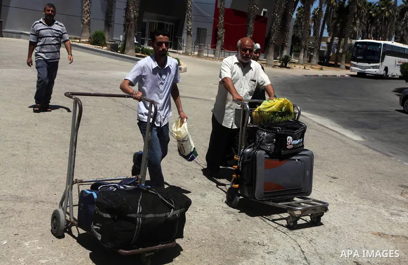 Palestinians return from Egypt cross into the southern Gaza Strip at the Rafah border crossing August 10, 2012. Egyptian military forces have captured six "terrorists" in the Sinai region after an attack on a police stat...