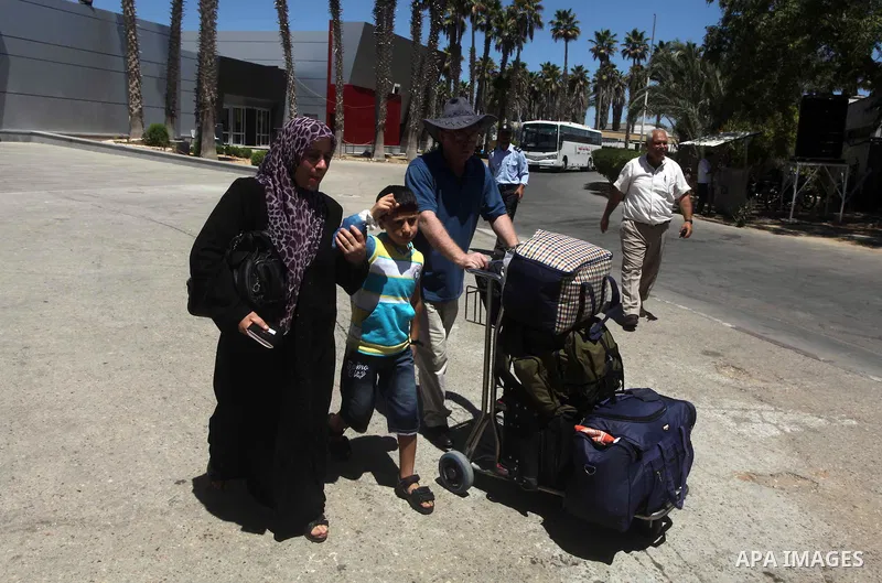 Palestinians return from Egypt cross into the southern Gaza Strip at the Rafah border crossing August 10, 2012. Egyptian military forces have captured six "terrorists" in the Sinai region after an attack on a police stat...