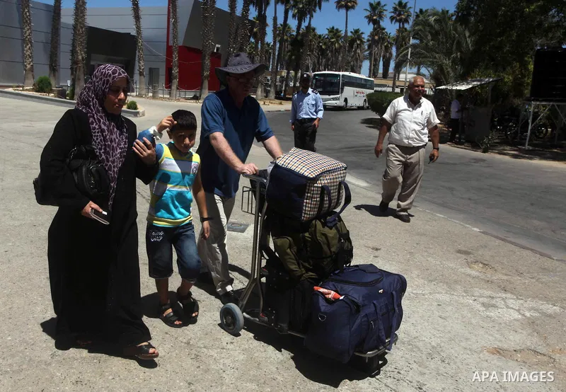 Palestinians return from Egypt cross into the southern Gaza Strip at the Rafah border crossing August 10, 2012. Egyptian military forces have captured six "terrorists" in the Sinai region after an attack on a police stat...