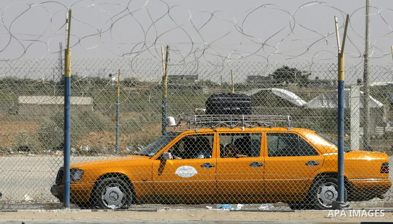 Palestinians return from Egypt cross into the southern Gaza Strip at the Rafah border crossing August 10, 2012. Egyptian military forces have captured six "terrorists" in the Sinai region after an attack on a police stat...