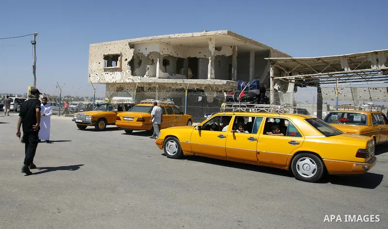 Palestinians return from Egypt cross into the southern Gaza Strip at the Rafah border crossing August 10, 2012. Egyptian military forces have captured six "terrorists" in the Sinai region after an attack on a police stat...
