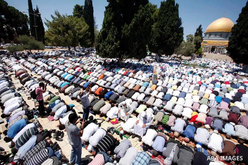 Muslim men pray outside the Dome of the Rock mosque situated in the al-Aqsa mosque compound, Islam's third most holy site, on August 10, 2011 in old city of Jerusalem, on a Friday during the Muslim holy fasting month of...