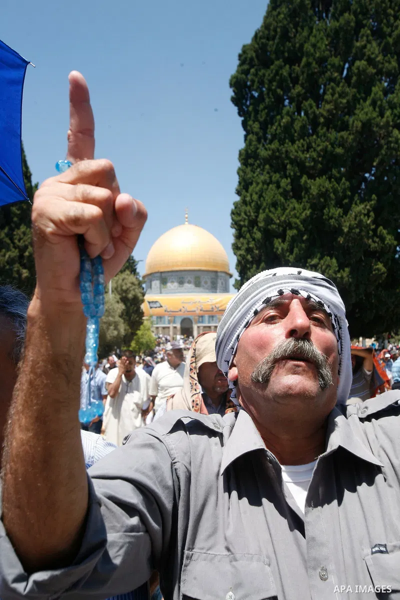 A Palestinian Muslim man prays outside the Dome of the Rock mosque situated in the al-Aqsa mosque compound, Islam's third most holy site, on August 10, 2011 in old city of Jerusalem, on a Friday during the Muslim holy fa...