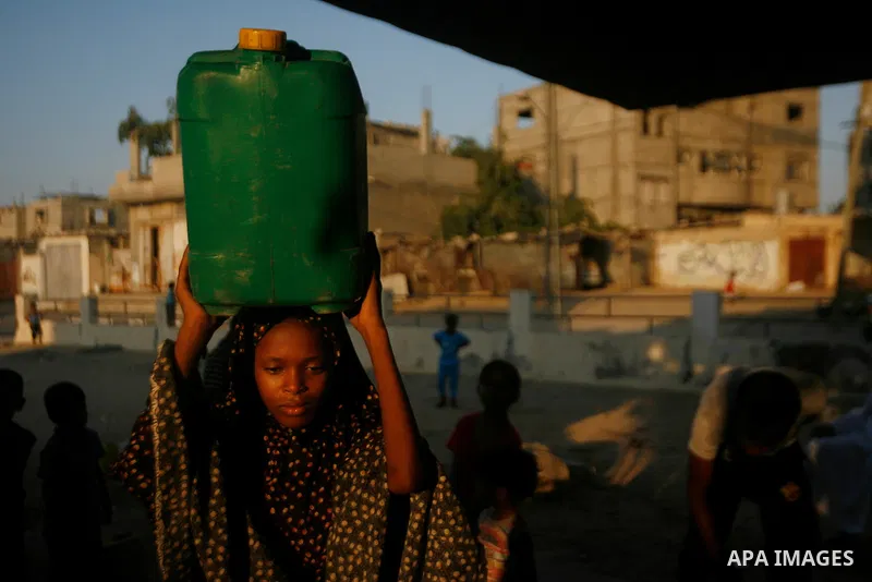 Palestinian children fill their bottles a potable water at a water purification station, in Rafah refugee camp southern Gaza Strip, on 11 August 2012. Palestinians suffer from the severe lack of potable water. Photo by E...
