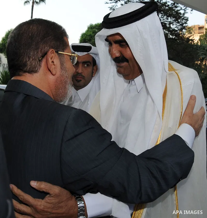 Egypt's President Mohamed Mursi, meets with Qatar's Emir Sheikh Hamad bin Khalifa al-Thani at the presidential palace in Cairo, August 11, 2012. Qatar said on Saturday it would deposit $2 billion at the Egyptian Central...