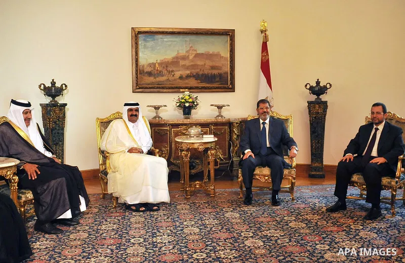 Egypt's President Mohamed Mursi, meets with Qatar's Emir Sheikh Hamad bin Khalifa al-Thani at the presidential palace in Cairo, August 11, 2012. Qatar said on Saturday it would deposit $2 billion at the Egyptian Central...