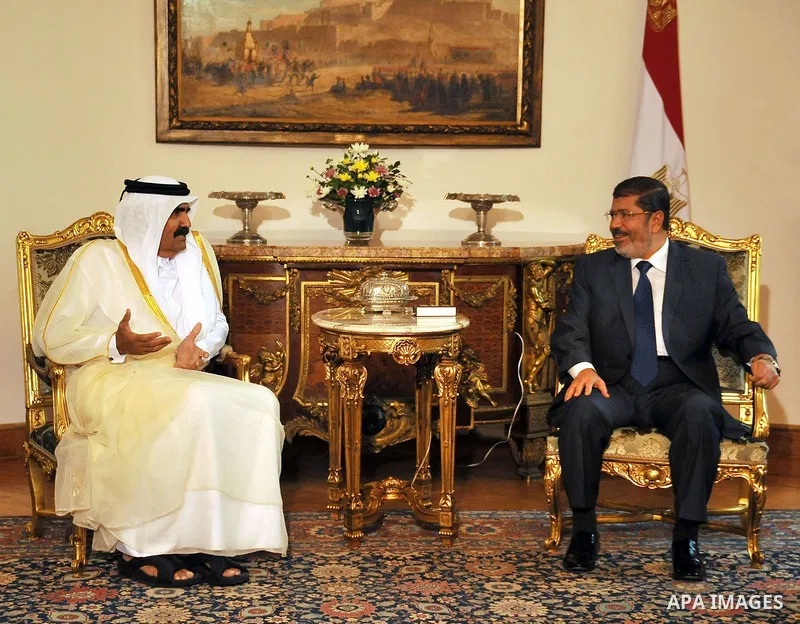 Egypt's President Mohamed Mursi, meets with Qatar's Emir Sheikh Hamad bin Khalifa al-Thani at the presidential palace in Cairo, August 11, 2012. Qatar said on Saturday it would deposit $2 billion at the Egyptian Central...