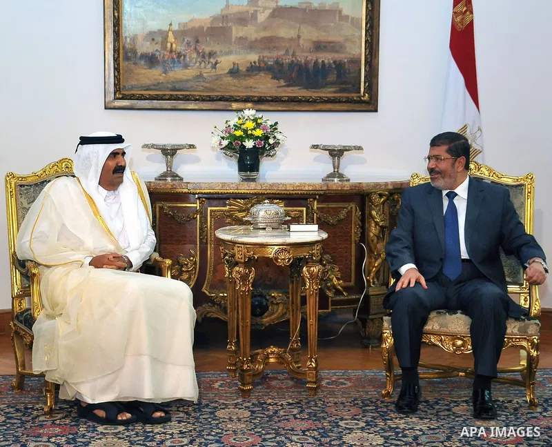 Egypt's President Mohamed Mursi, meets with Qatar's Emir Sheikh Hamad bin Khalifa al-Thani at the presidential palace in Cairo, August 11, 2012. Qatar said on Saturday it would deposit $2 billion at the Egyptian Central...