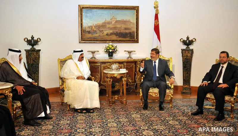 Egypt's President Mohamed Mursi, meets with Qatar's Emir Sheikh Hamad bin Khalifa al-Thani at the presidential palace in Cairo, August 11, 2012. Qatar said on Saturday it would deposit $2 billion at the Egyptian Central...