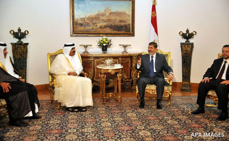 Egypt's President Mohamed Mursi, meets with Qatar's Emir Sheikh Hamad bin Khalifa al-Thani at the presidential palace in Cairo, August 11, 2012. Qatar said on Saturday it would deposit $2 billion at the Egyptian Central...