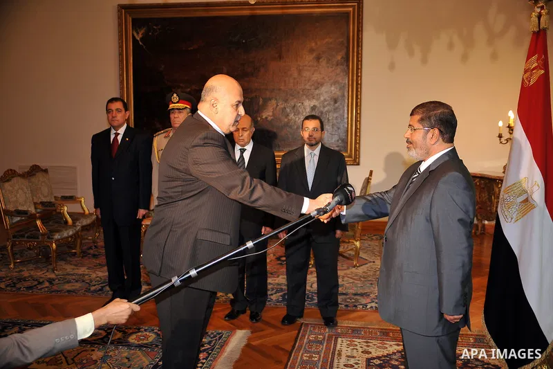 President Mohammed Morsi (R) shaking hands with his newly appointed vice president, former judge Mahmud Mekki during a swearing-in ceremony at the presidential palace in Cairo on August 12, 2012. Egypt's Islamist preside...