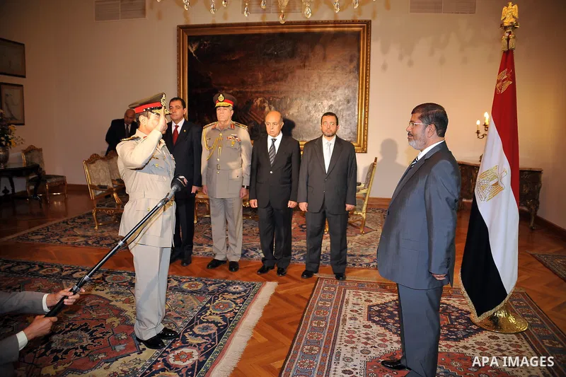 Newly nominated Defence Minister Abdul-Fatah al-Sessi (L) saluting Egyptian President Mohamed Morsi after he was swore in, at the Presidential palace, in Cairo, Egypt, 12 August 2012. Egyptian President Mohammed Morsi on...