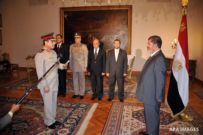 Egyptian President Mohammed Morsi swears in newly-appointed Minister of Defense, Lt. Gen. Abdel-Fattah el-Sissi, in Cairo, Egypt, Sunday, Aug. 12, 2012. Egypt's Islamist president ordered his former defense minister and...