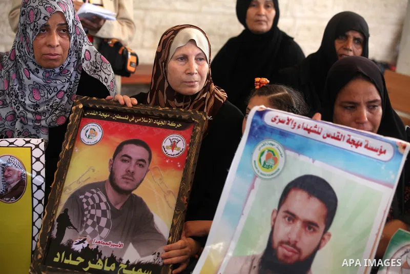 Palestinian women hold pictures of their relatives prisoners in Israeli jails as they gather in an activity calling for their liberty at the Red Cross headquarters in Gaza City on 13 August 2012. Photo by Majdi Fathi