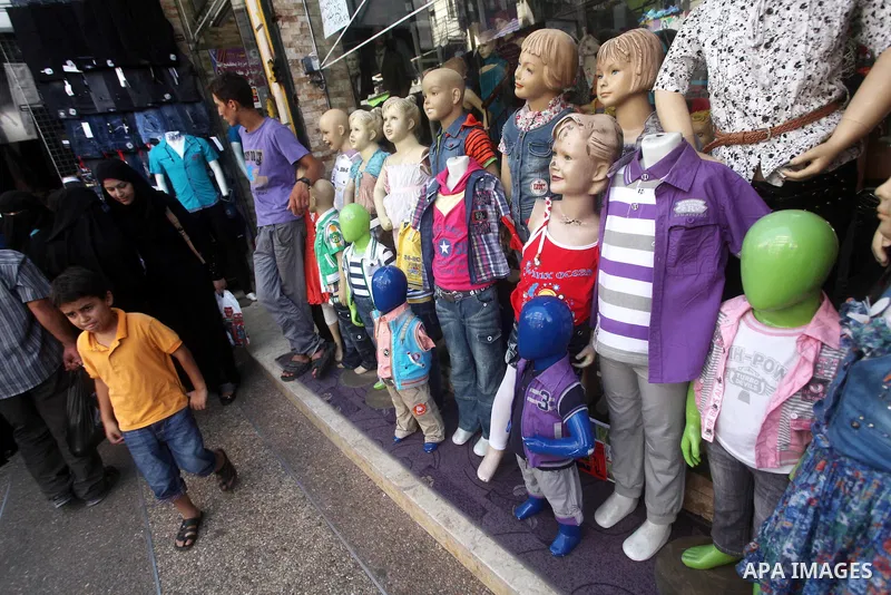 Palestinians shop at a market in Gaza city on Aug 13,2012, as Muslims over the world prepare to celebrate Eid al-Fitr, a three day holiday marking the end of the religious month of Ramadan in which believers abstain from...