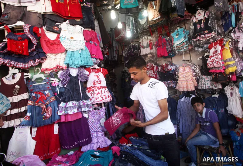 A Palestinian vendor displays his goods at a market in Gaza city on Aug 13,2012, as Muslims over the world prepare to celebrate Eid al-Fitr, a three day holiday marking the end of the religious month of Ramadan in which...