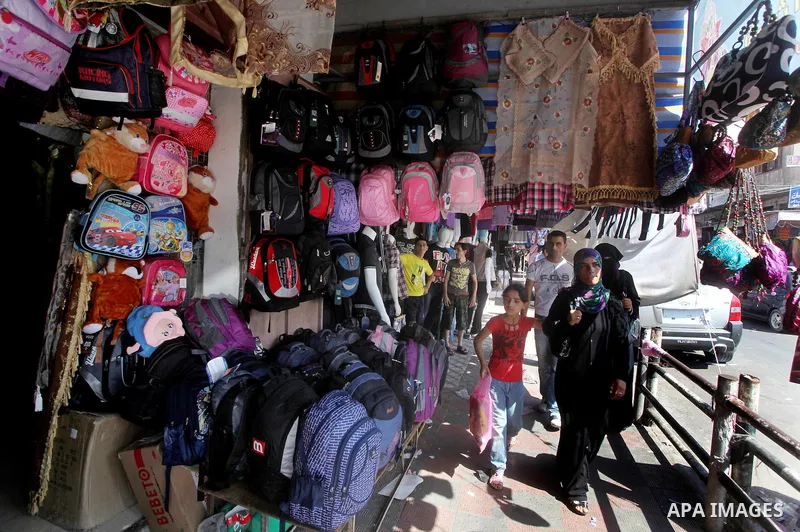 Palestinians shop at a market in Gaza city on Aug 13,2012, as Muslims over the world prepare to celebrate Eid al-Fitr, a three day holiday marking the end of the religious month of Ramadan in which believers abstain from...