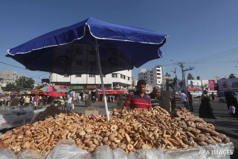 A Palestinian vendor displays his goods at a market in Gaza city on Aug 13,2012, as Muslims over the world prepare to celebrate Eid al-Fitr, a three day holiday marking the end of the religious month of Ramadan in which...