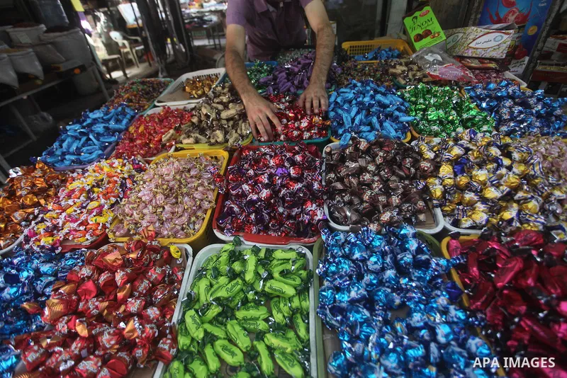 A Palestinian vendor displays his goods at a market in Gaza city on Aug 13,2012, as Muslims over the world prepare to celebrate Eid al-Fitr, a three day holiday marking the end of the religious month of Ramadan in which...