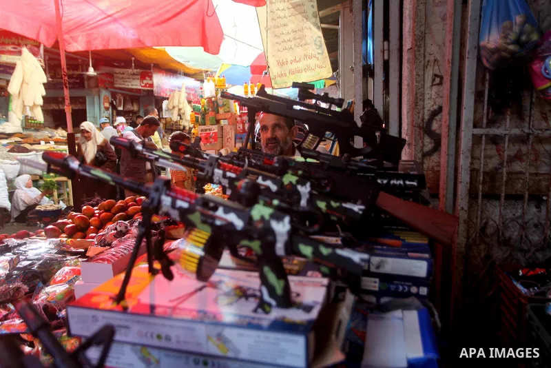 A Palestinian vendor displays his goods at a market in Gaza city on Aug 13,2012, as Muslims over the world prepare to celebrate Eid al-Fitr, a three day holiday marking the end of the religious month of Ramadan in which...
