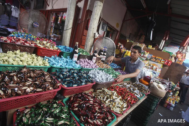 A Palestinian vendor displays his goods at a market in Gaza city on Aug 13,2012, as Muslims over the world prepare to celebrate Eid al-Fitr, a three day holiday marking the end of the religious month of Ramadan in which...