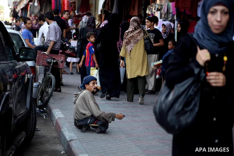 A Palestinian handicapped man sit at a market in Gaza city on Aug 13,2012, as Muslims over the world prepare to celebrate Eid al-Fitr, a three day holiday marking the end of the religious month of Ramadan in which believ...