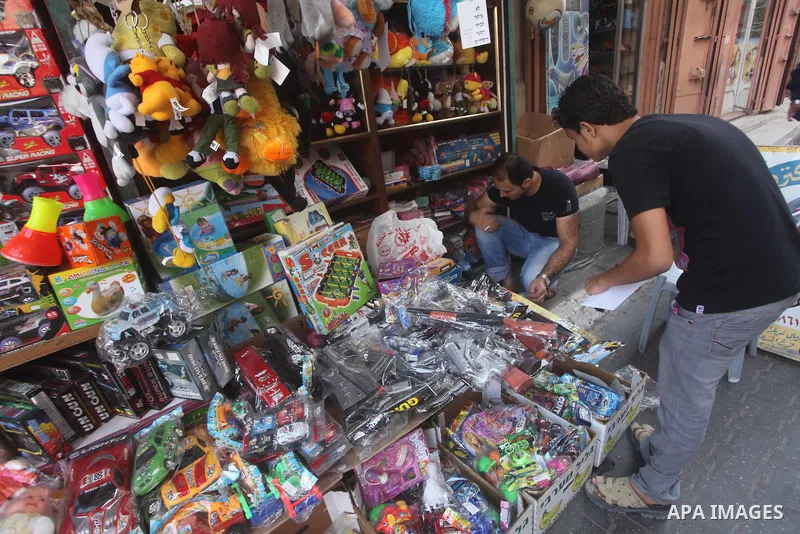 A Palestinian vendor displays his goods at a market in Gaza city on Aug 13,2012, as Muslims over the world prepare to celebrate Eid al-Fitr, a three day holiday marking the end of the religious month of Ramadan in which...