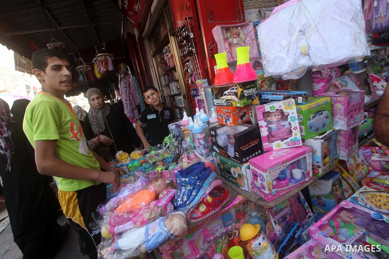 A Palestinian vendor displays his goods at a market in Gaza city on Aug 13,2012, as Muslims over the world prepare to celebrate Eid al-Fitr, a three day holiday marking the end of the religious month of Ramadan in which...